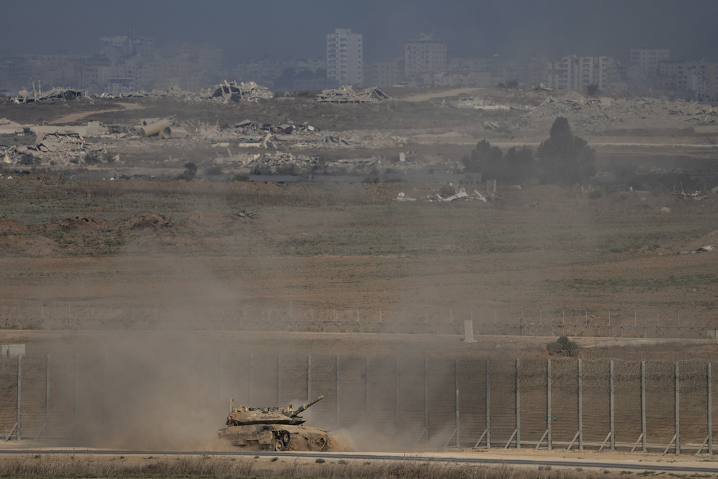 An Israeli tank moves along the Israeli-Gaza border as seen from southern Israel, Thursday, Aug. 28, 2025. (AP Photo/Maya Levin)