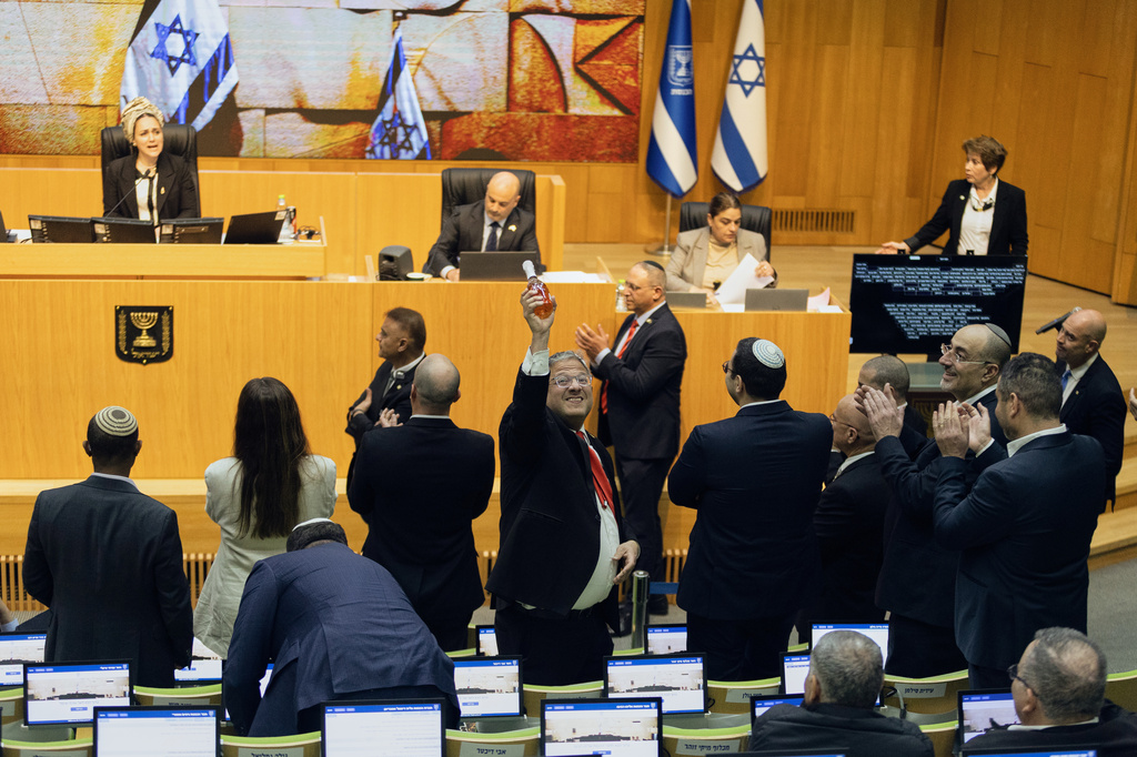 Israel's Minister of National Security, Itamar Ben-Gvir, center, and lawmakers celebrate after Israel's parliament passed a law approving the death penalty for Palestinians convicted of murdering Israelis, at the Knesset in Jerusalem Monday, March 30, 2026. (AP Photo/Itay Cohen)