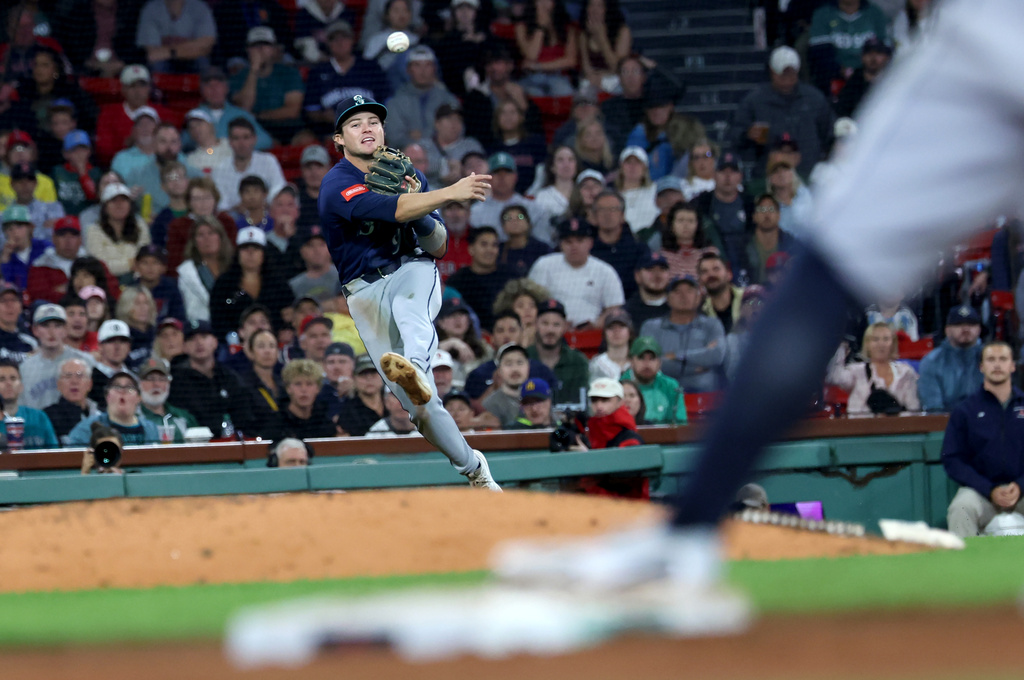 Seattle Mariners third baseman Brock Rodden throws to first base for an attempted out during the sixth inning of a baseball game against the Boston Red Sox, Tuesday, Sept. 1, 2026, in Boston. (AP Photo/Mark Stockwell)
