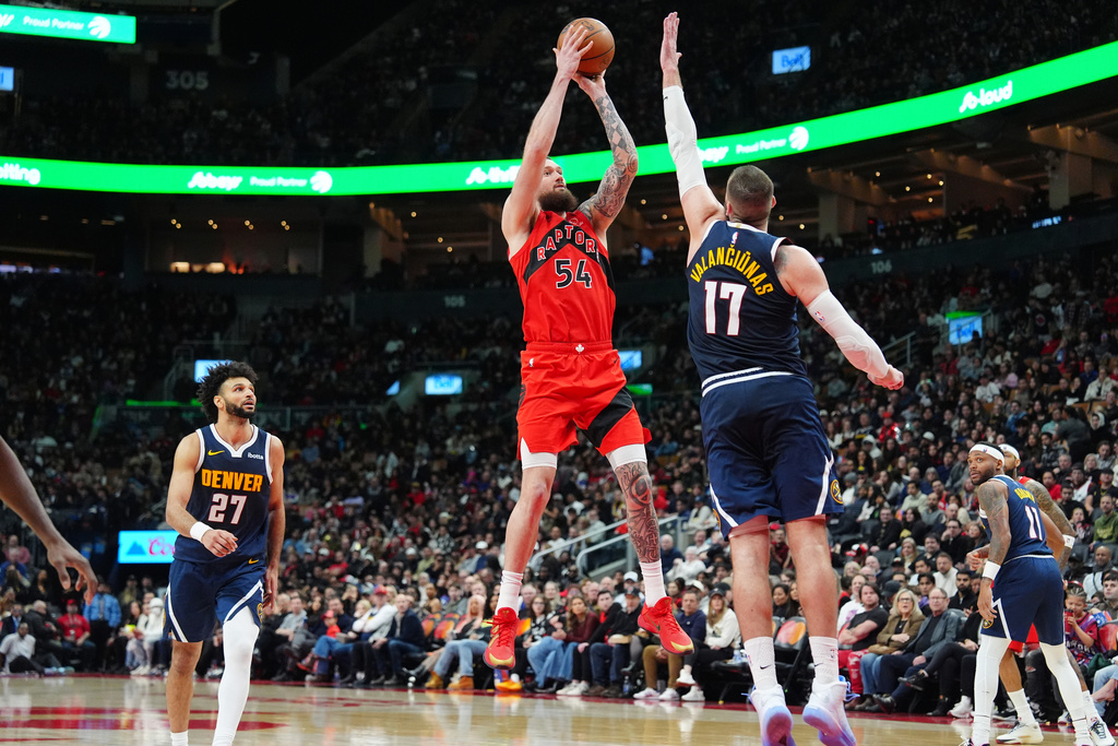 Toronto Raptors forward/center Sandro Mamukelashvili (54) shoots over Denver Nuggets center Jonas Valančiūnas (17) during the second half of an NBA basketball game in Toronto, Wednesday Dec. 31, 2025. (Frank Gunn/The Canadian Press via AP)