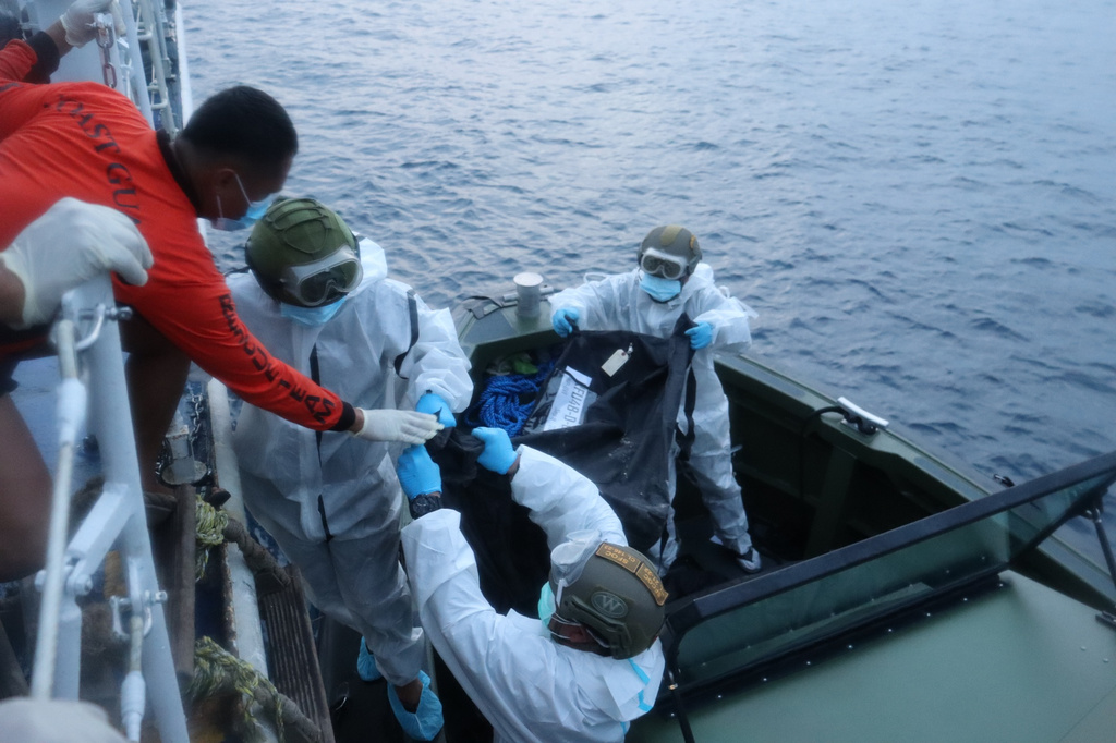 In this handout provided by the Philippine Coast Guard, rescuers transfer the remains of victims of the recent fire on the MV June Aster ferry on Friday Sept. 11, 2026 off Coron, Palawan province, western Philippines. (Philippine Coast Guard via AP)