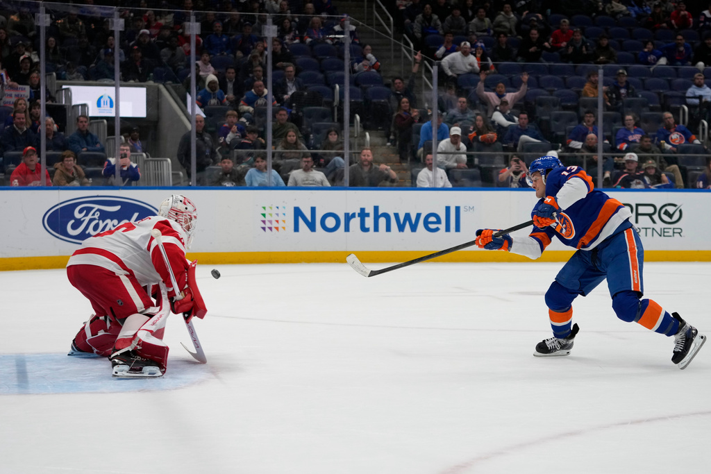 New York Islanders' Mathew Barzal (13) shoots the puck past Detroit Red Wings goaltender Cam Talbot (39) for a goal during the second period of an NHL hockey game Thursday, Oct. 23, 2025, at UBS Arena in Elmont, N.Y. (AP Photo/Frank Franklin II)