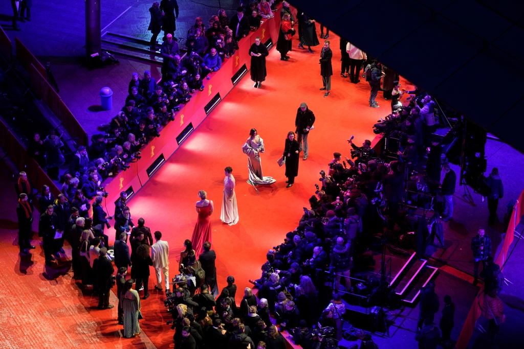 Guests pose for photographers at the opening ceremony red carpet of the International Film Festival, Berlinale, in Berlin, Thursday, Feb. 12, 2026. (AP Photo/Markus Schreiber).
