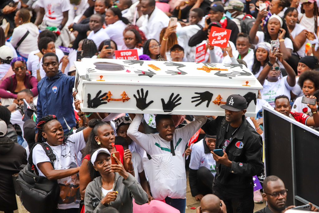 Demonstrators carry a coffin, during a march against rising cases of femicide, in downtown Nairobi, Kenya, Monday, June 1, 2026. (AP Photo/Patrick Ngugi)