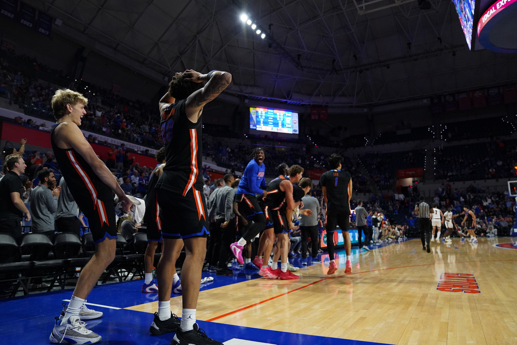 Florida players cheer as Olivier Rioux dunks the ball on Saint Francis during the second half of an NCAA college basketball game Wednesday, Dec. 17, 2025, in Gainesville, Fla. (AP Photo/Morgan Hurd)