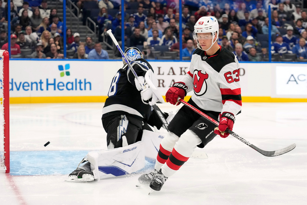 New Jersey Devils left wing Jesper Bratt (63) reacts after scoring a shorthanded goal past Tampa Bay Lightning goaltender Andrei Vasilevskiy (88) during the third period of an NHL hockey game Saturday, Oct. 11, 2025, in Tampa, Fla. (AP Photo/Chris O'Meara)