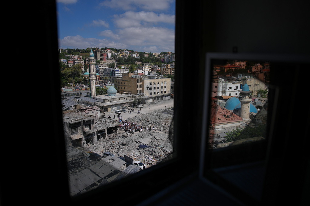 Lebanese Shiites take part in an Ashoura procession amid buildings destroyed by Israeli strikes, when Shiites commemorate the martyrdom of Imam Hussein, the grandson of the Prophet Muhammad, in Nabatiyeh, southern Lebanon, Friday, June 26, 2026. (AP Photo/Hassan Ammar)