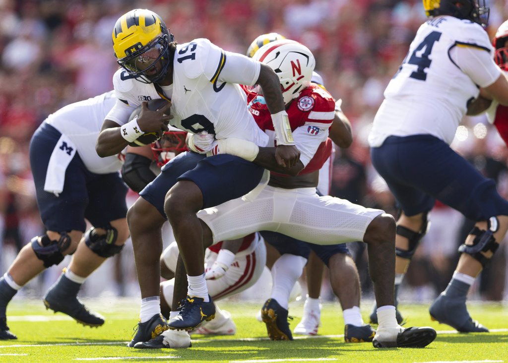 Nebraska's Dasan McCullough, right, sacks Michigan quarterback Bryce Underwood during the first half of an NCAA college football game Saturday, Sept. 20, 2025, in Lincoln, Neb. (AP Photo/Rebecca S. Gratz)