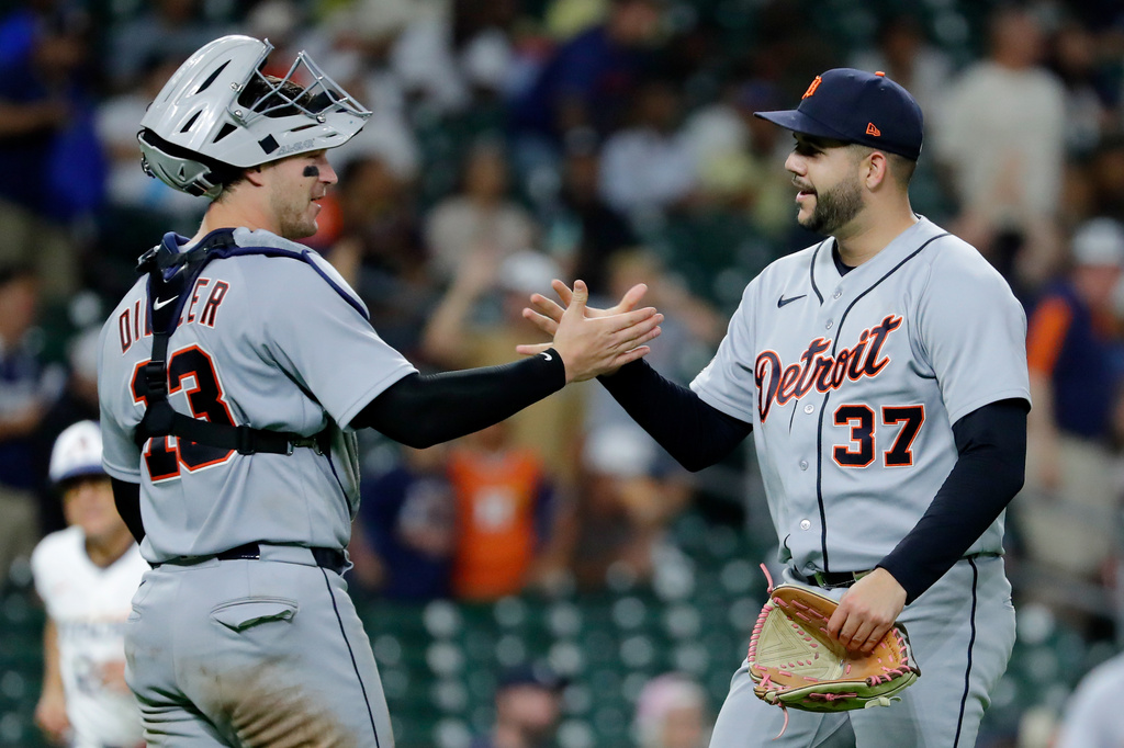 Detroit Tigers catcher Dillon Dingler (13) and closing pitcher Enmanuel de Jesus (37) shake hands after their team defeated the Houston Astros in a baseball game Monday, June 15, 2026, in Houston. (AP Photo/Michael Wyke)