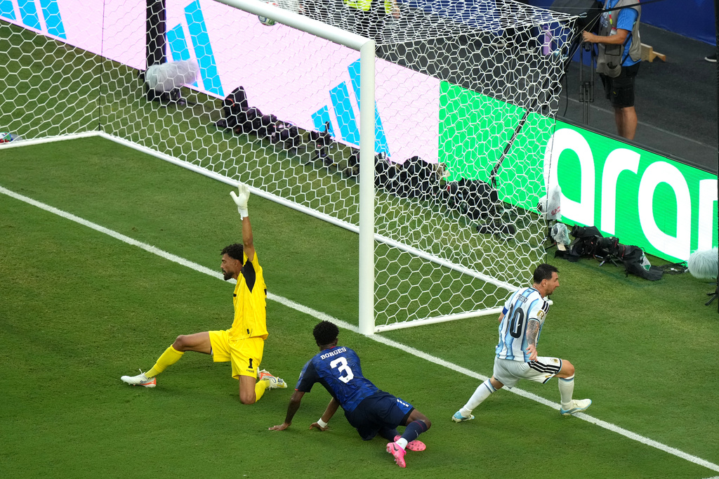 Argentina's Lionel Messi (10) scores their first goal against Cape Verde goalkeeper Vozinha (1) and Diney Borges (3) during the World Cup round of 32 soccer match between Argentina and Cape Verde in Miami Gardens, Fla., Friday, July 3, 2026. (AP Photo/Marta Lavandier)