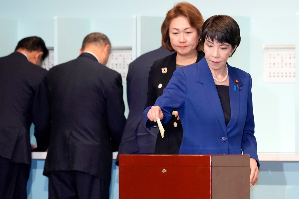 FILE - Candidate Sanae Takaichi, right, casts her ballot at the Liberal Democratic Party's (LDP) leadership election at the party headquarters, Sept. 27, 2024, in Tokyo. (AP Photo/Hiro Komae, Pool, File)