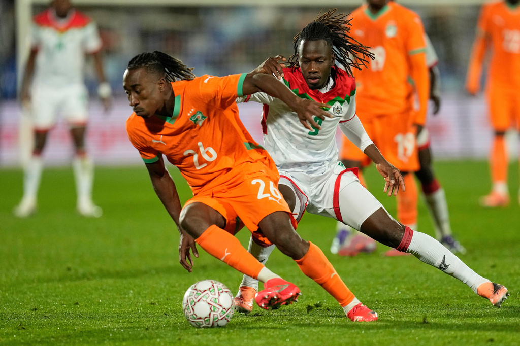 FILE - FILE - Ivory Coast's Yan Diomande, left, and Burkina Faso's Issa Kabore challenge during the Africa Cup of Nations best of 16 soccer match between Ivory Coast and Burkina Faso in Marrakech, Morocco, on Jan. 6, 2026. (AP Photo/Themba Hadebe, File)