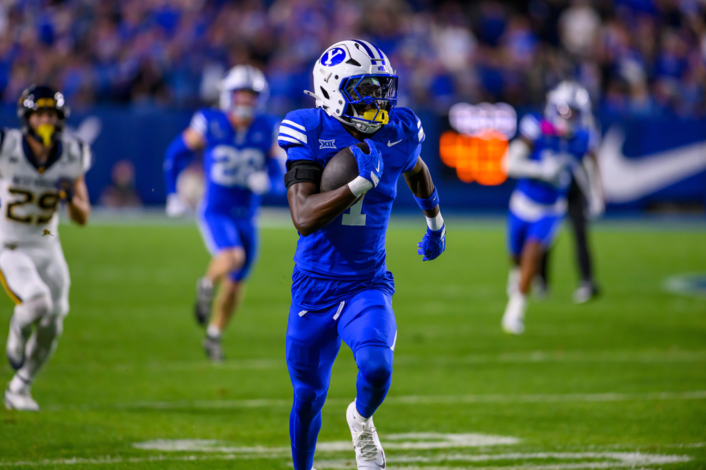BYU cornerback Therrian Alexander III (1) runs the ball after he intercepted a pass during the first half of an NCAA college football game against West Virginia, Friday, Oct. 3, 2025, in Provo, Utah. (AP Photo/Tyler Tate)