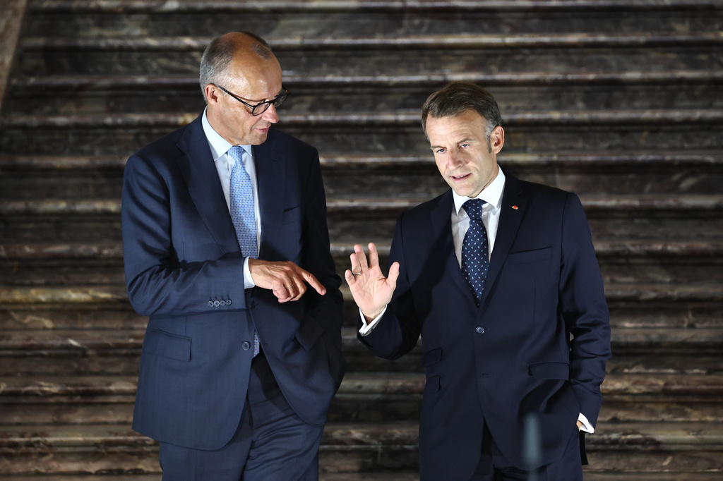 German Chancellor Friedrich Merz, left, talks with French President Emmanuel Macron as they arrive for a press conference following a meeting of the Franco-German Ministerial Council in Brühl, Germany, Friday, July 17, 2026. (Oliver Berg/dpa via AP)