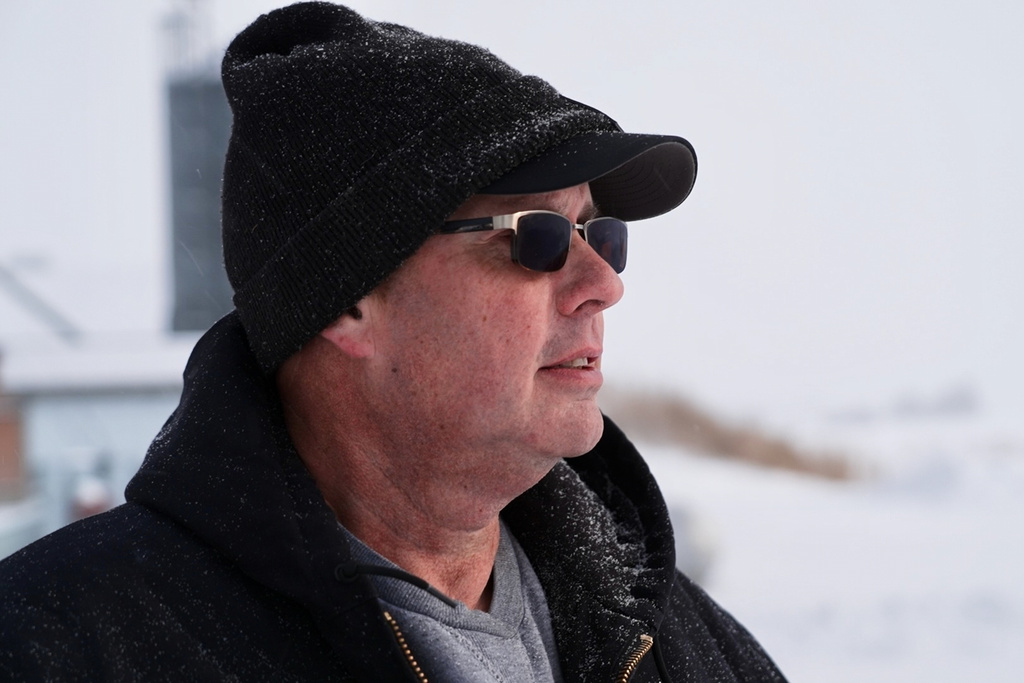 This screenshot taken from video shows Charlie Radman, a corn and soybean farmer, standing on the land his family has owned since 1899, near Randolph, Minn., Wednesday, Dec. 10, 2025. (AP Photo/Mark Vancleave)