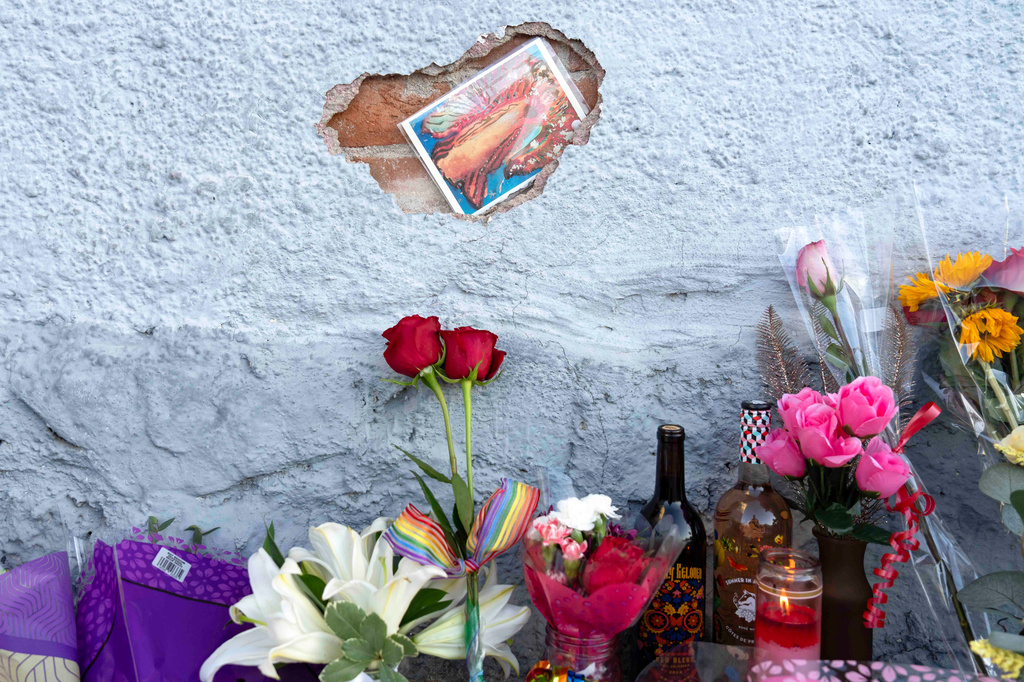 A growing memorial sits outside the Venture-N bar in Tucson, Ariz., Tuesday, Sept. 1, 2026, for Vincent Anthony Siquieros and Cameron Davis Capara, who were fatally shot in the parking lot of the gay bar shortly after midnight on Monday. (AP Photo/Rebecca Noble)