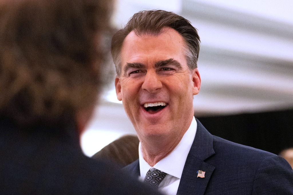 FILE - Oklahoma Gov. Kevin Stitt speaks with an individual following an event at the National Governors Association Winter Meeting, Feb. 19, 2026, in Washington. (AP Photo/Allison Robbert, File)