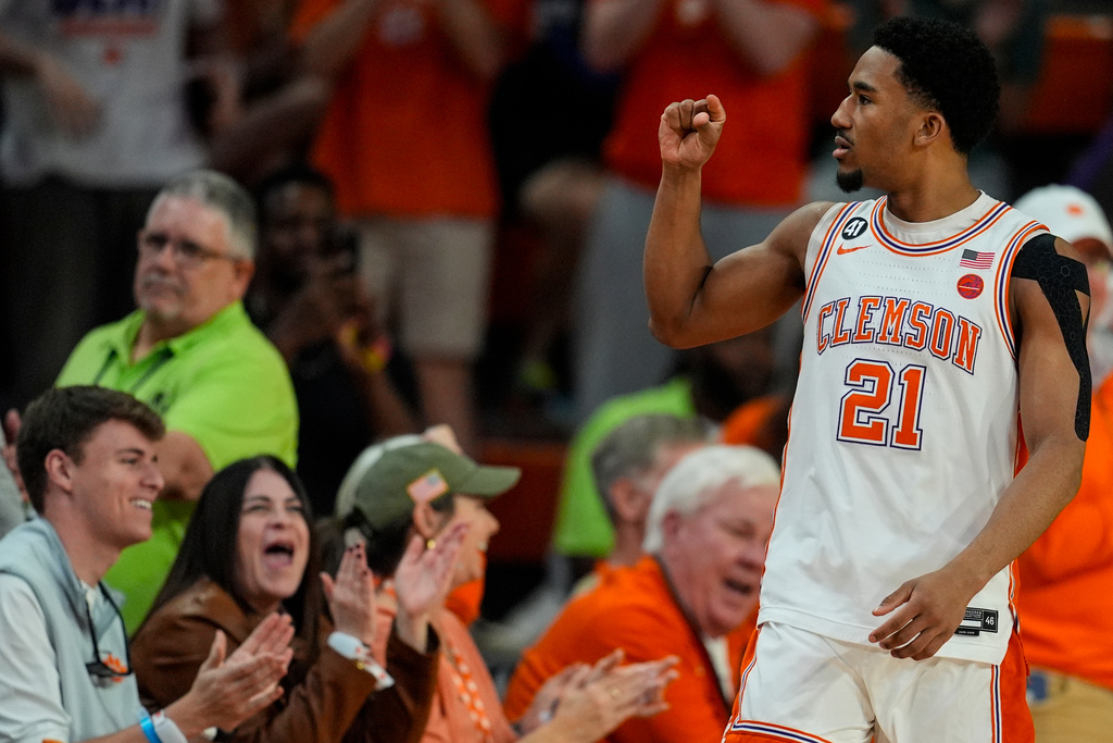 Clemson guard Ace Buckner (21) celebrates a basket against Louisville during the second half of an NCAA basketball game, Saturday, Feb. 28, 2026, in Clemson, S.C. (AP Photo/Mike Stewart)