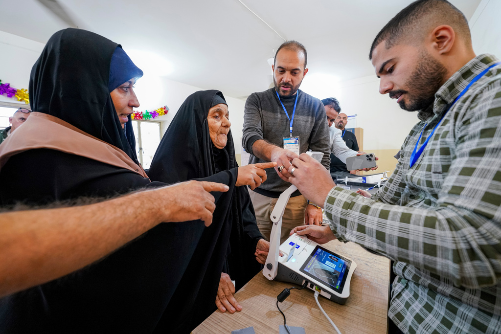 FILE - Voters gather to cast their vote at a ballot station in the country's parliamentary election in Najaf, Iraq, Nov. 11, 2025. (AP Photo/Anmar Khalil, File)