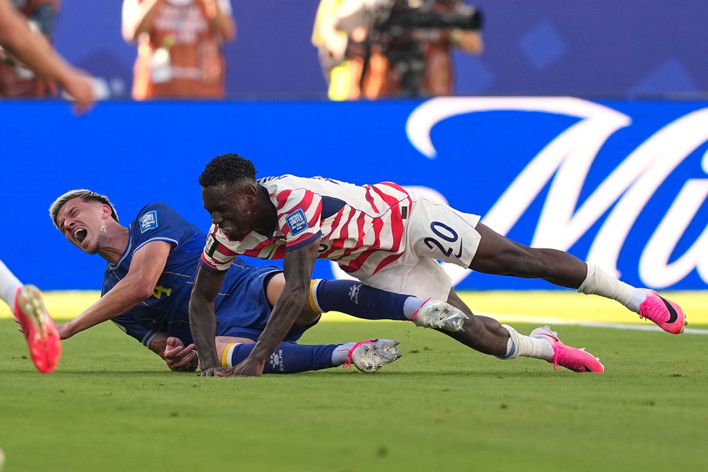 Bosnia's Tarik Muharemovic (4) reacts after a tackle form United States' Folarin Balogun (20) during the World Cup round of 32 soccer match between the United States and Bosnia in Santa Clara, Calif., near San Francisco, Wednesday, July 1, 2026. (AP Photo/Julio Cortez)