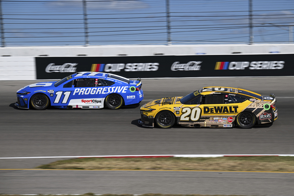 Denny Hamlin (11) and Christopher Bell (20) compete during a NASCAR Cup Series auto race at World Wide Technology Raceway, Sunday, Sept. 7, 2025, in Madison, Ill. (AP Photo/Connor Hamilton)