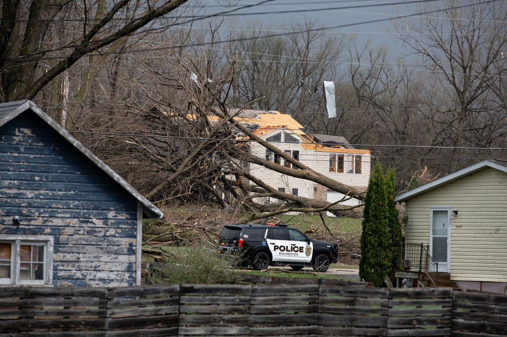 A fallen tree lays on a house after a severe storm that tore through the Upper Midwest on Friday, April 17, 2026, in Rochester, Minn. (Hollie Bennett Piotrowicz via AP)