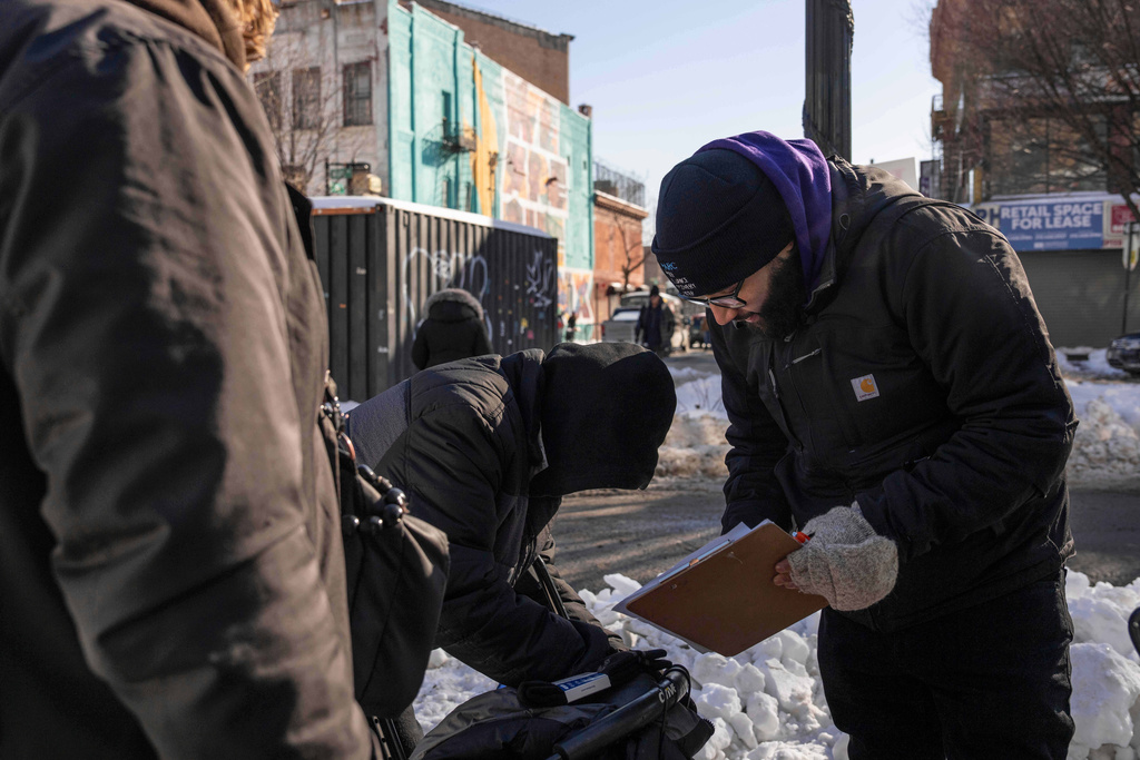 Members of Peer Alliance Recovery Center at Samaritan Daytop Village distribute items to people in need in the Bronx borough of New York, Wednesday, Jan. 28, 2026. (AP Photo/Yuki Iwamura)