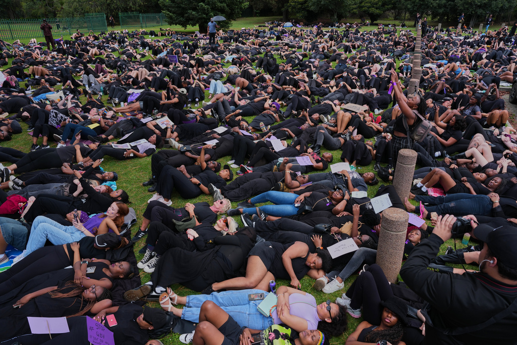 Participants lie on the ground during a gender-based violence protest at the forecourt of the botanical gardens in Johannesburg, South Africa, Friday, Nov. 21, 2025. (Misper Apawu)