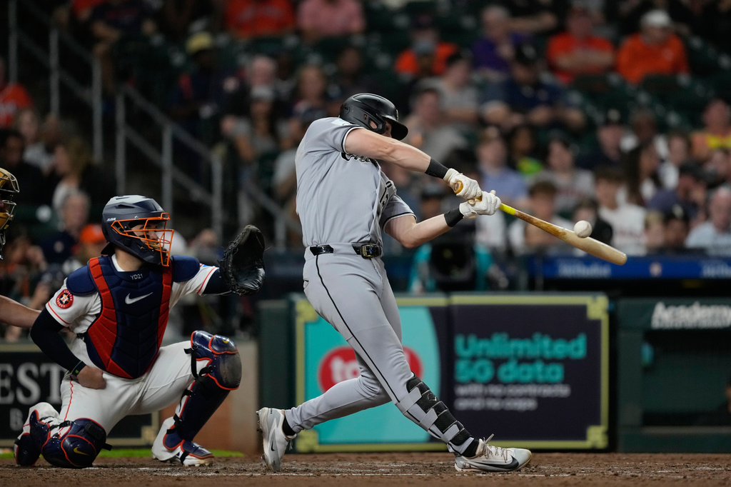 Chicago White Sox's Colson Montgomery, right, hits a two-un double as Houston Astros catcher Yainer Diaz reaches for the pitch during the fifth inning of a baseball game Tuesday, Sept. 1, 2026, in Houston. (AP Photo/David J. Phillip)