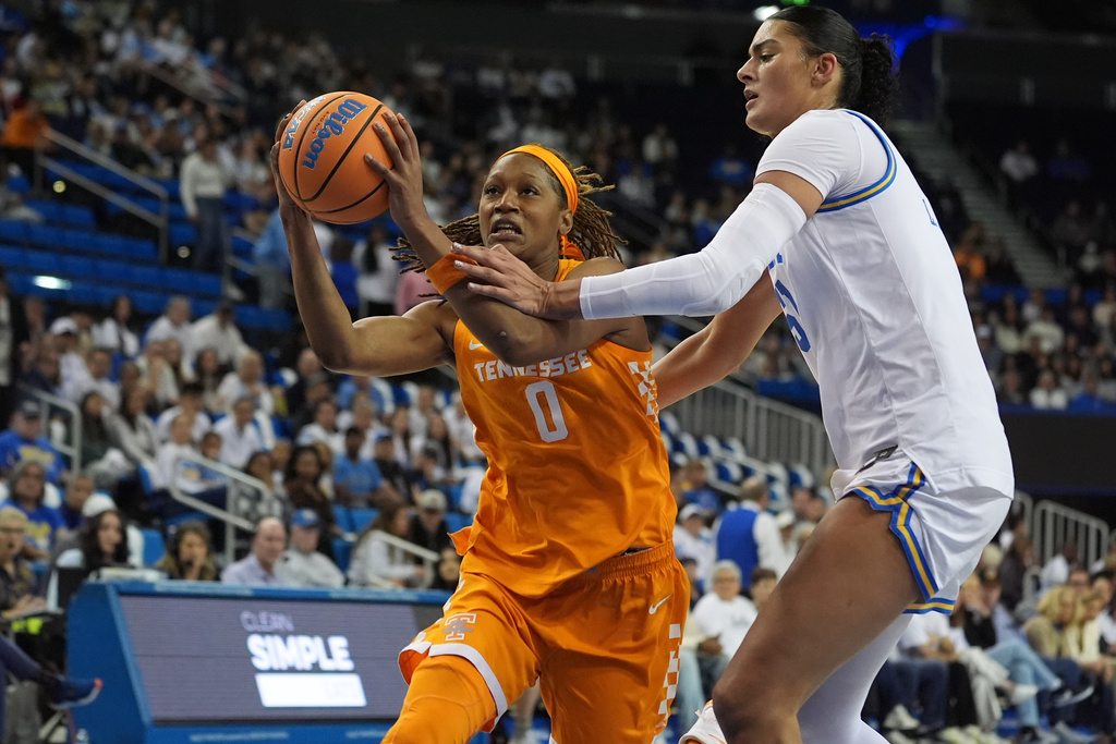 Tennessee forward Janiah Barker (0) drives against UCLA center Lauren Betts during the first half of an NCAA college basketball game in Los Angeles, Sunday, Nov. 30, 2025. (AP Photo/Damian Dovarganes)
