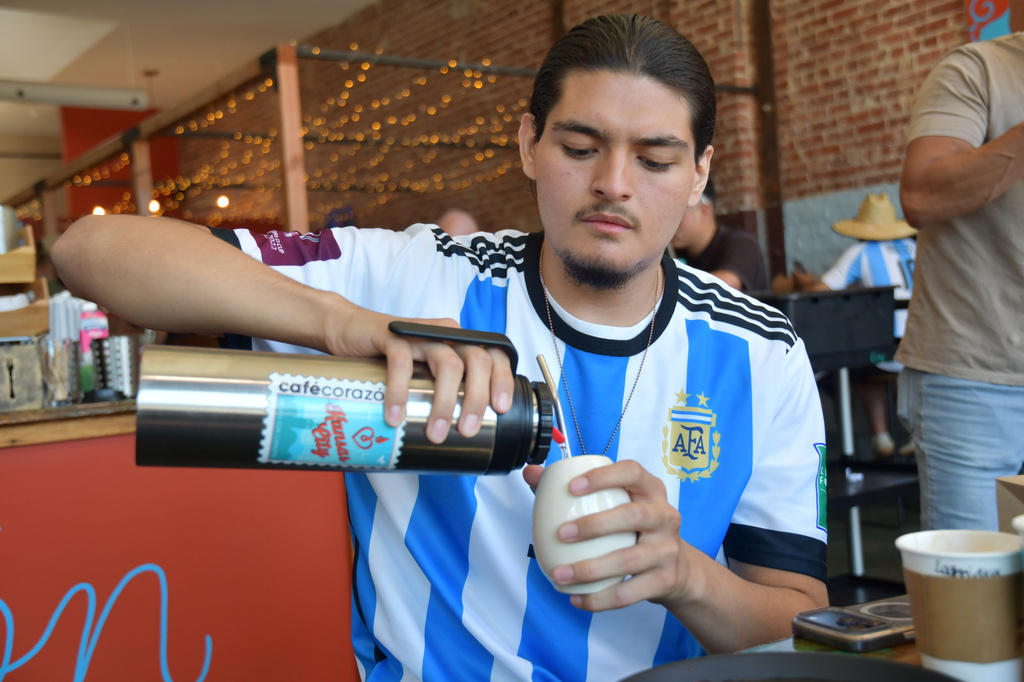 Sebastian Cufre, from Albuquerque, N.M., pours hot water over his cup of yerba mate at Cafe Corazon, Monday, June 15, 2026, in Kansas City, Mo. (AP Photo/Kristin M. Hall)