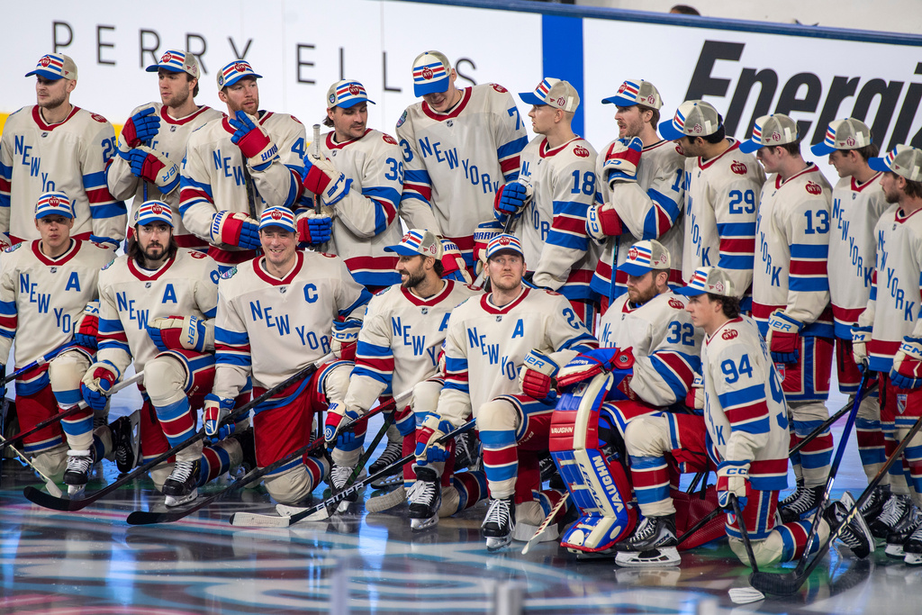 New York Rangers players gather for a team picture during practice for the NHL Winter Classic outdoor hockey game, Thursday, Jan. 1, 2026, in Miami. (AP Photo/Michael Laughlin)