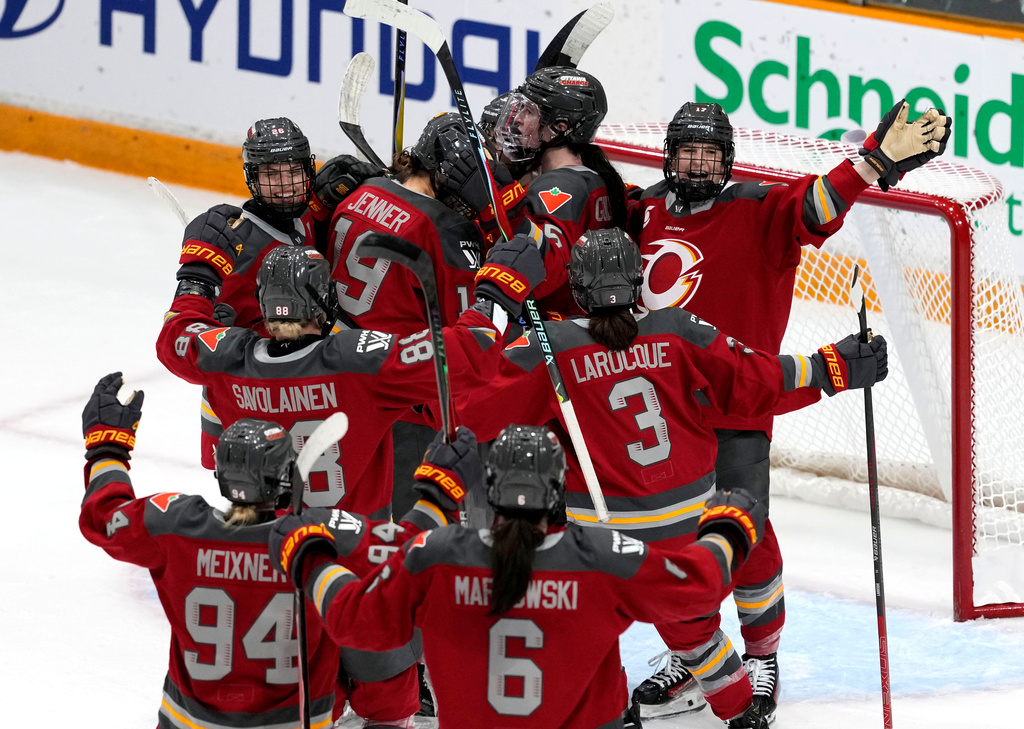 Ottawa Charge's Gabbie Hughes (top right) celebrates the win against the Vancouver Goldeneyes with teammates in PWHL hockey action in Ottawa, on Wednesday, Nov. 26, 2025. (Justin Tang/The Canadian Press via AP)