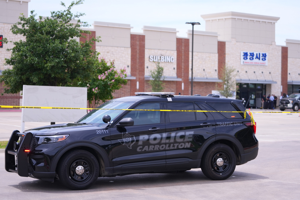Officials respond to the scene of a shooting Tuesday, May 5, 2026, at K Towne Plaza in Carrollton, Texas. (AP Photo/Julio Cortez)