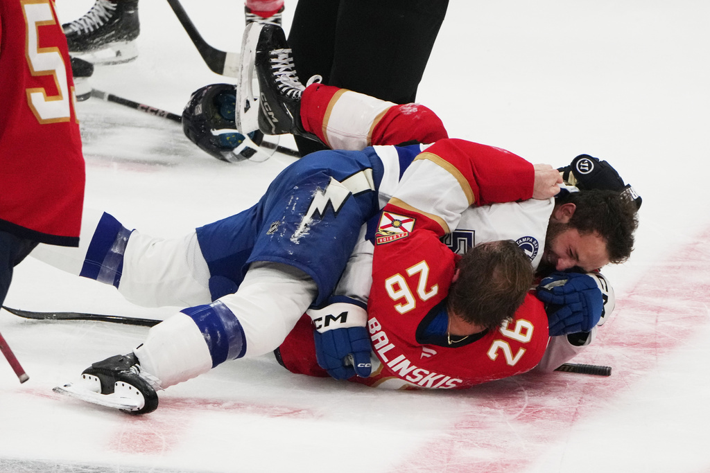 FILE - Florida Panthers defenseman Uvis Balinskis (26) and Tampa Bay Lightning Dylan Duke, right, scuffle during the third period of a preseason NHL hockey game, Saturday, Oct. 4, 2025, in Sunrise, Fla. (AP Photo/Lynne Sladky, File)