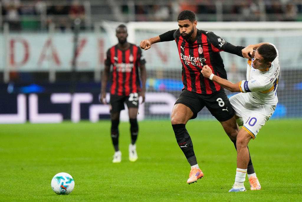 AC Milan's Ruben Loftus-Cheek, left, and Lecce's Medon Berisha fight for the ball during an Italian Cup qualifying soccer match between AC Milan and Lecce, at the San Siro stadium in Milan, Italy, Tuesday, Sept. 23, 2025. (AP Photo/Luca Bruno)