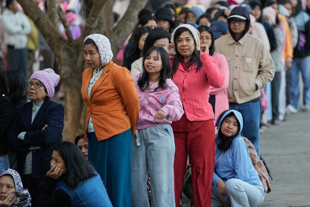 Voters line up to cast their ballots at a polling station in Naypyitaw, Myanmar, Sunday, Dec. 28, 2025. (AP Photo/Aung Shine Oo)