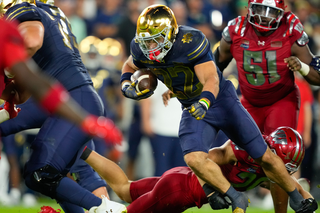 Notre Dame running back Aneyas Williams (22) runs the ball during the second half of an NCAA college football game against Wisconsin Sunday, Sept. 6, 2026, in Green Bay, Wis. (AP Photo/Kayla Wolf)
