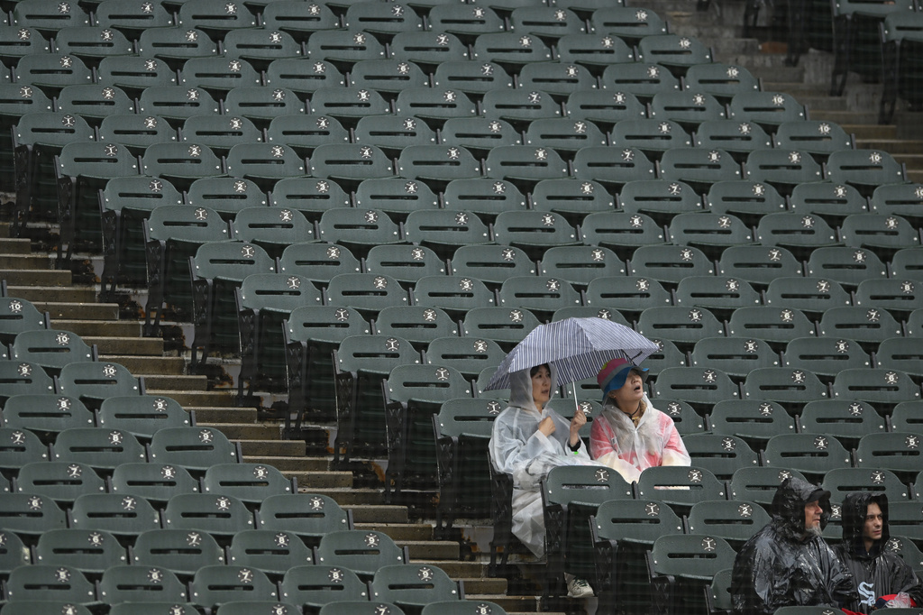 Fans look on during a rain delay before a baseball game between the Chicago White Sox and the Detroit Tigers, Sunday, Sept. 20, 2026, in Chicago. (AP Photo/Paul Beaty)