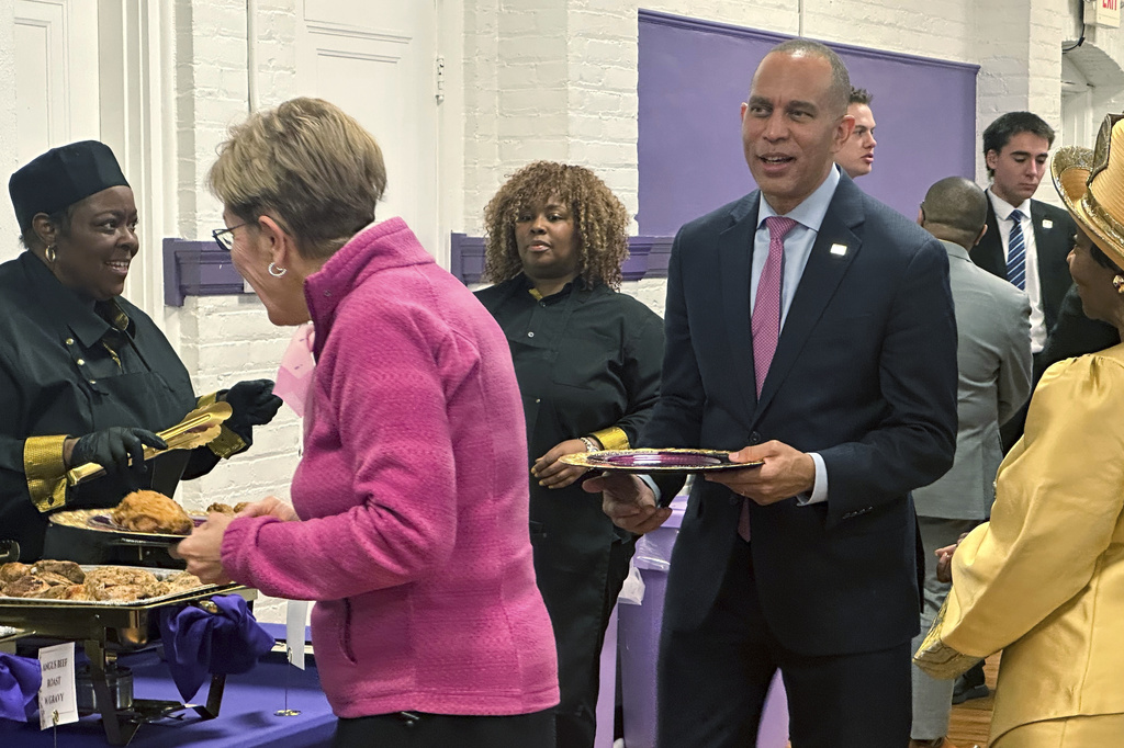 In this photo taken with a smartphone, House Democratic Leader Hakeem Jeffries, standing with Rep. Marcy Kaptur, D-Ohio, join a church luncheon after Sunday services at the Worship Center of Toledo on Oct. 18, 2026, in Toledo, Ohio. (AP Photo/Lisa Mascaro)
