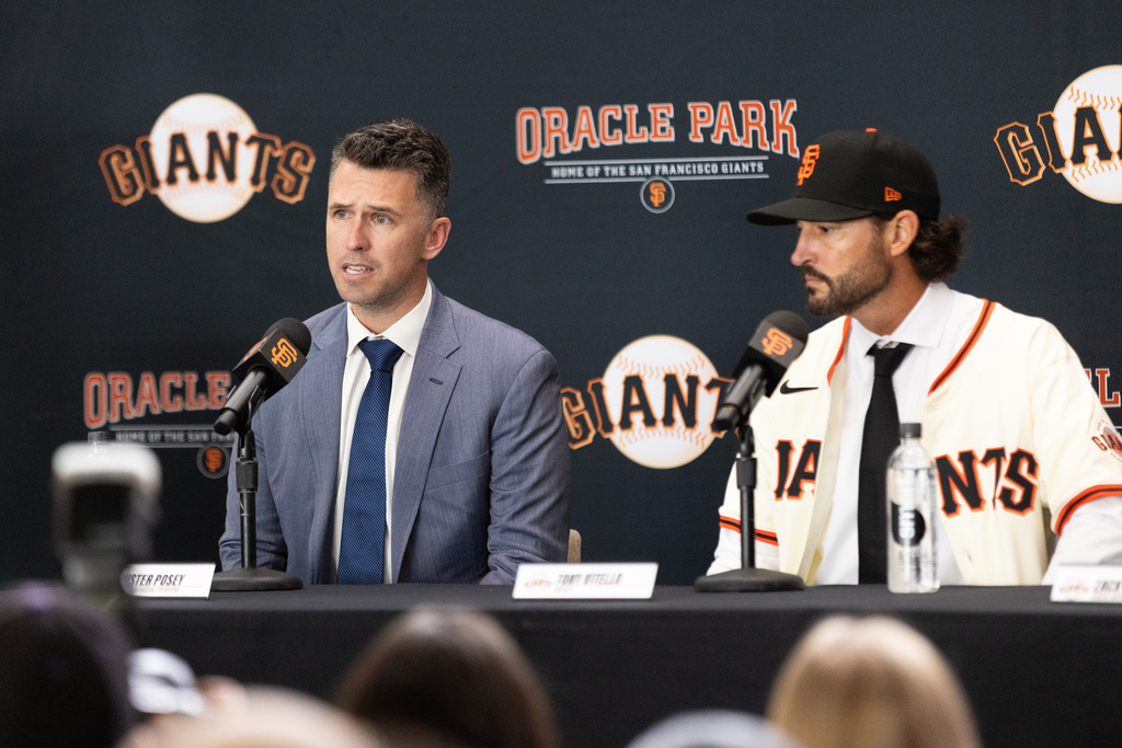 San Francisco Giants President of Baseball Operations Buster Posey, left, speasks as Tony Vitello listens during a press conference welcoming Vitello as the new manager of the baseball team, Thursday, Oct. 30, 2025, in San Francisco. (AP Photo/Benjamin Fanjoy)