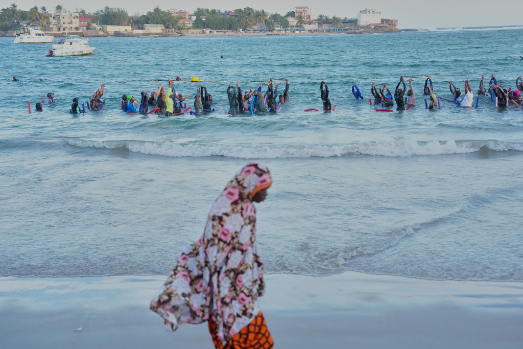 FILE - People take part in a group aquatic therapy session in the ocean in Dakar, Senegal, Saturday, Dec. 13, 2025. (AP Photo/Misper Apawu, File)