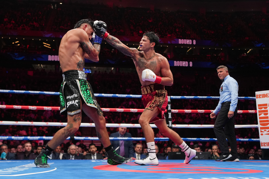 Ryan Garcia, right, fights Mario Barrios in a WBC welterweight title boxing match Saturday, Feb. 21, 2026, in Las Vegas. (AP Photo/Lucas Peltier)