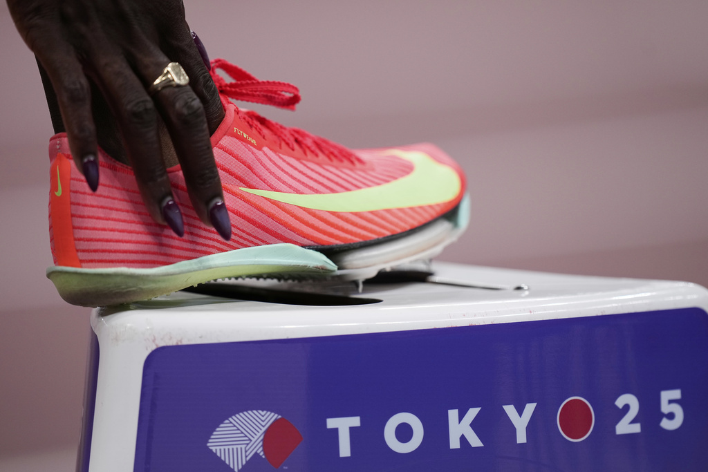 Britain's Victoria Ohuruogu adjusts her footwear as she prepares to compete in the women's 400 meters heat at the World Athletics Championships in Tokyo, Sunday, Sept. 14, 2025. (AP Photo/Eugene Hoshiko)