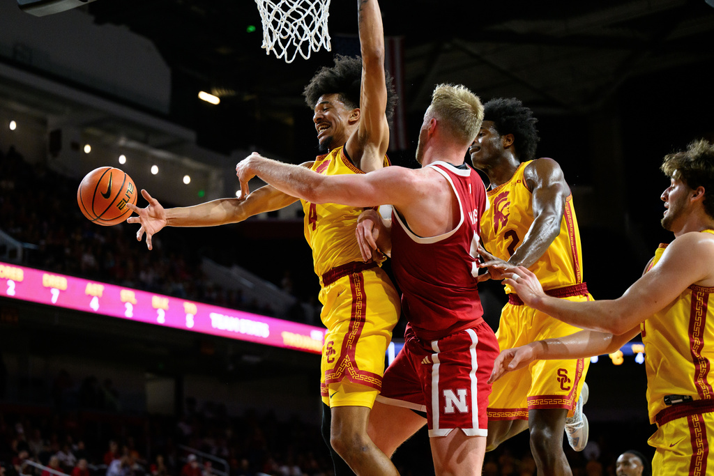 Nebraska forward Rienk Mast, second from left, passes the ball past Southern California forward Chad Baker-Mazara (4) during the first half of an NCAA college basketball game Saturday, Feb. 28, 2026, in Los Angeles. (AP Photo/William Liang)