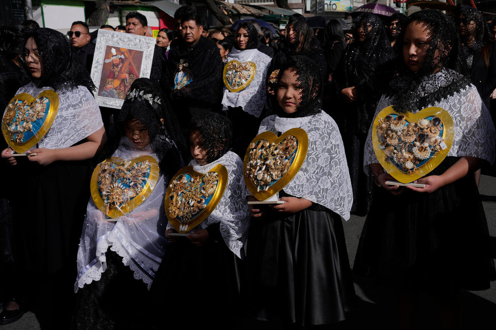 Young women and girls carry jeweled hearts representing the Virgin Mary at a Good Friday procession during Holy Week in La Paz, Bolivia, Friday, April 3, 2026. (AP Photo/Juan Karita)