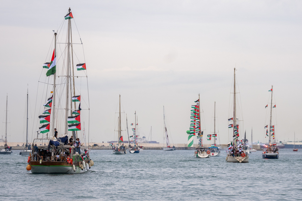 Boats carrying activists and humanitarian aid for Palestinians in Gaza reposition in the port during a symbolic send-off as part of the Global Sumud Flotilla, in Barcelona, Spain, Sunday, April 12, 2026. (AP Photo/Joan Mateu Parra)