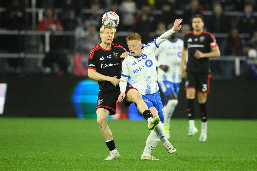 D.C. United defender Matti Peltola, left, and CF Montreal midfielder Matty Longstaff, front right, battle for the ball during the first half of an MLS soccer match, Saturday, May 23, 2026, in Washington. (AP Photo/Nick Wass)