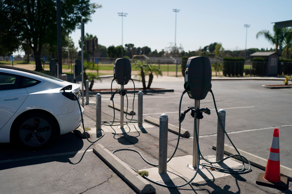 FILE - Electric vehicle chargers are seen in the parking lot of South El Monte High School, in South El Monte, Calif., Aug. 26, 2022. (AP Photo/Jae C. Hong, File)