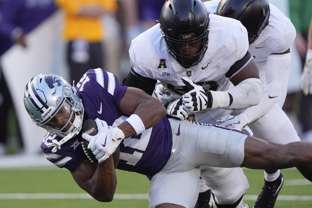Kansas State wide receiver Jaron Tibbs (12) is tackled by Army defensive lineman Deshontez Gray during the first half of an NCAA college football game Saturday, Sept. 6, 2025, in Manhattan, Kan. (AP Photo/Charlie Riedel)